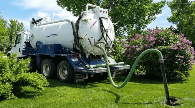 Professional vacuum truck performing residential drainage and septic maintenance in Tallahassee, FL