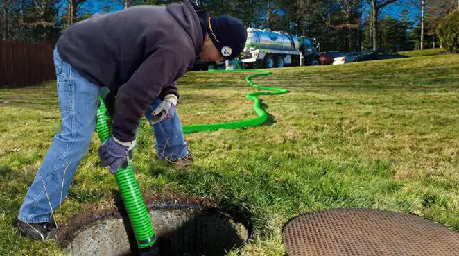 Service technician performing residential septic pumping and drainage maintenance in Tallahassee, FL